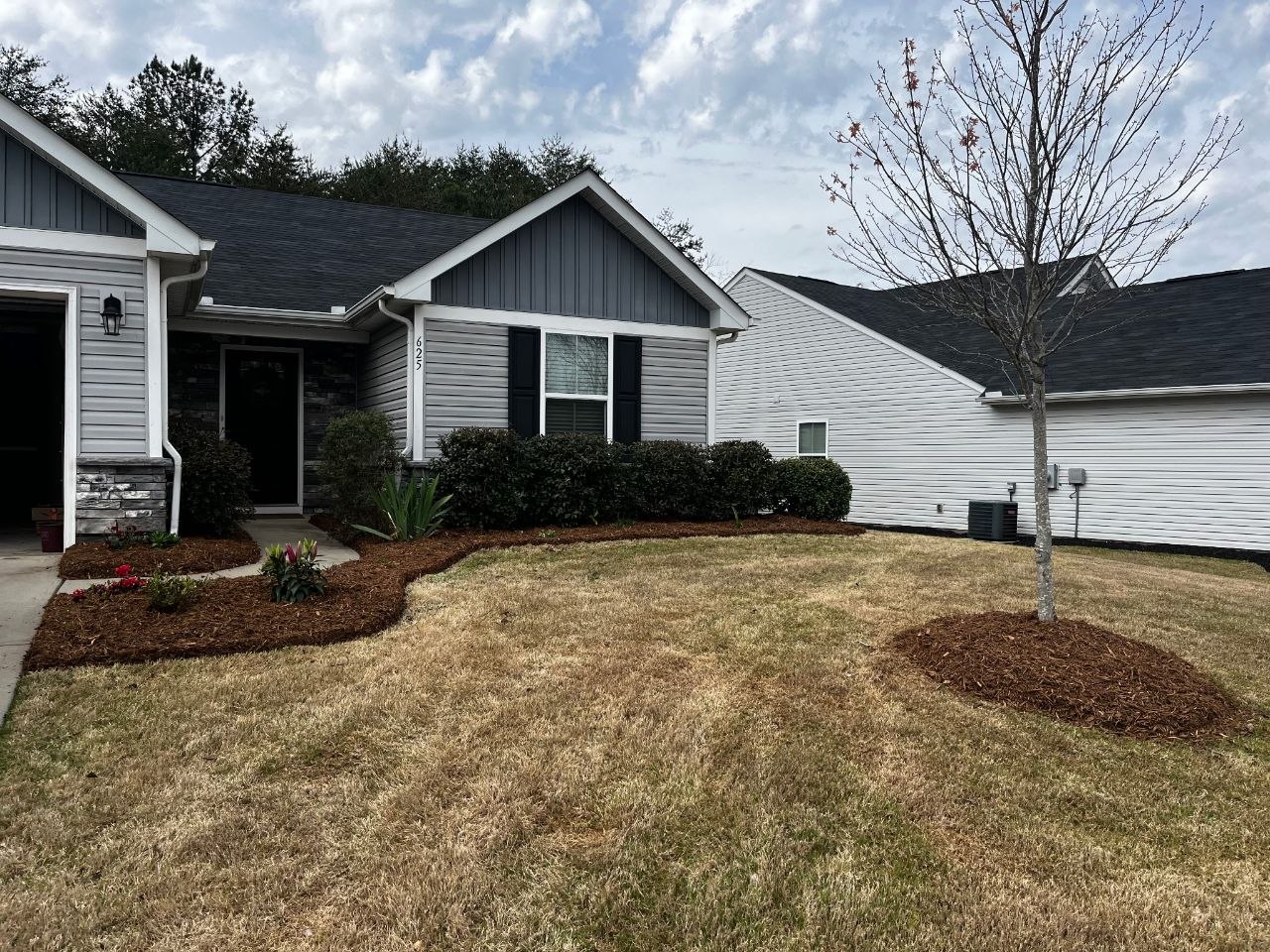 Curvilinear mulch beds with evergreens and flowering plants — Redwood Landscaping Marietta SC